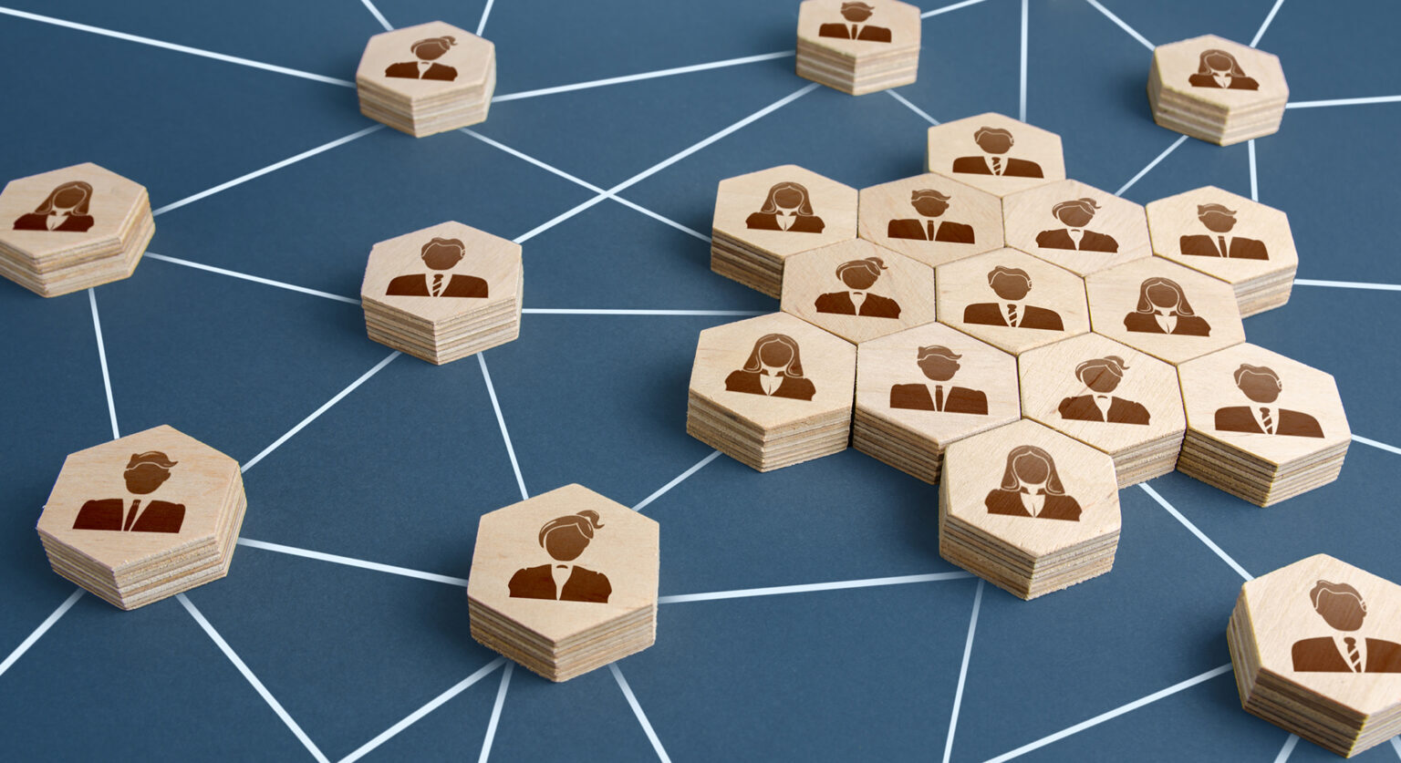 Six sided blocks with silhouettes of people on them laid out individually and in groups. Between those blocks, there are white lines connecting them. 